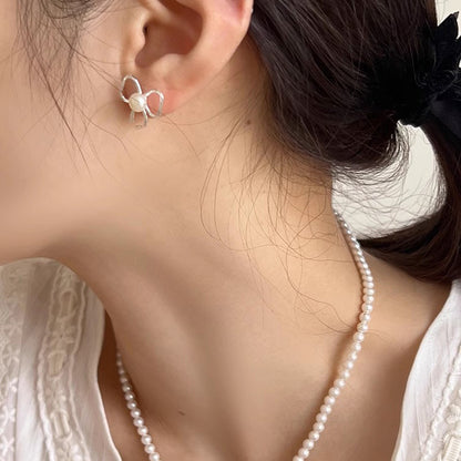 Pearl stud earrings with bow design