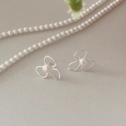 Pearl stud earrings with bow design